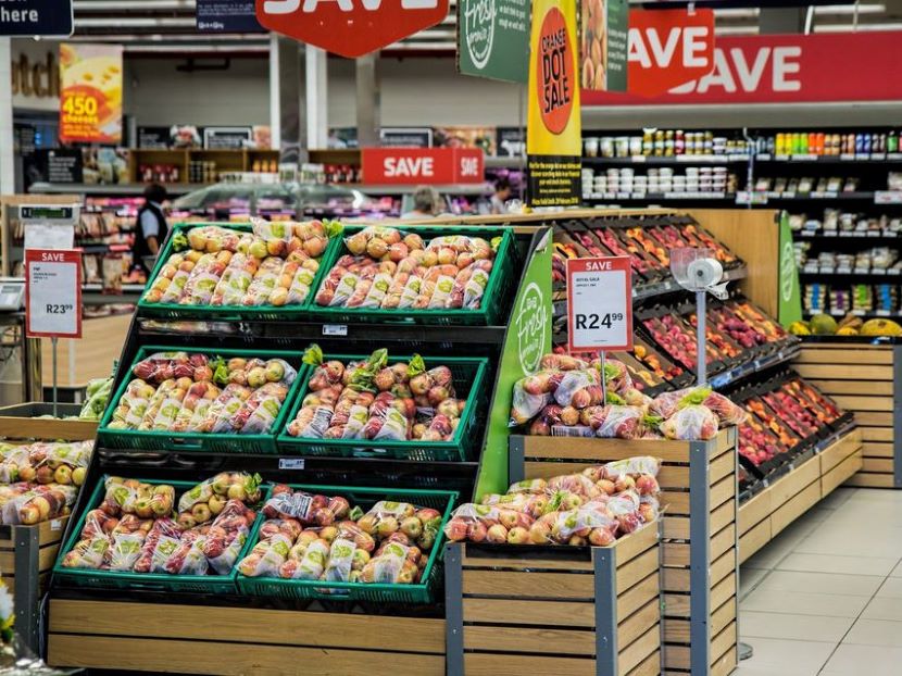 Fachverkäuferin im Lebensmittelhandwerk bedient Kundin an einer Bäckereitheke